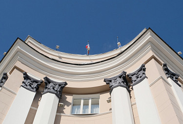 Улан-Удэ. Верхняя часть фасада здания бурятского парламента с флагами России, Бурятии и прожекторами