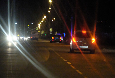 Машины с включенными фарами на ночной трассе